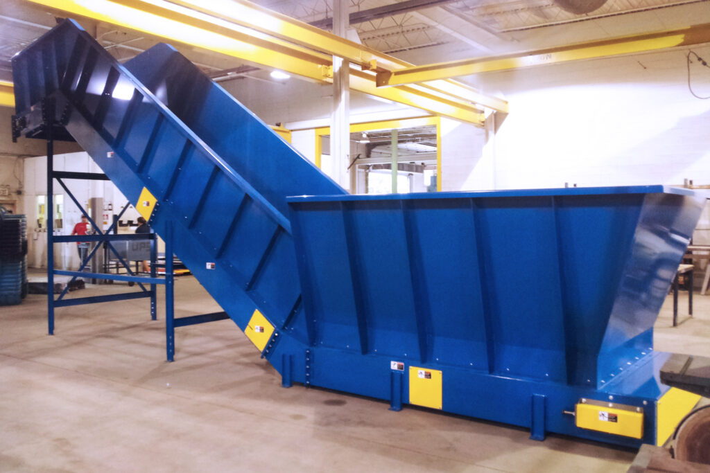 side view of large blue Endura-Veyor steel belt conveyor large dumpster