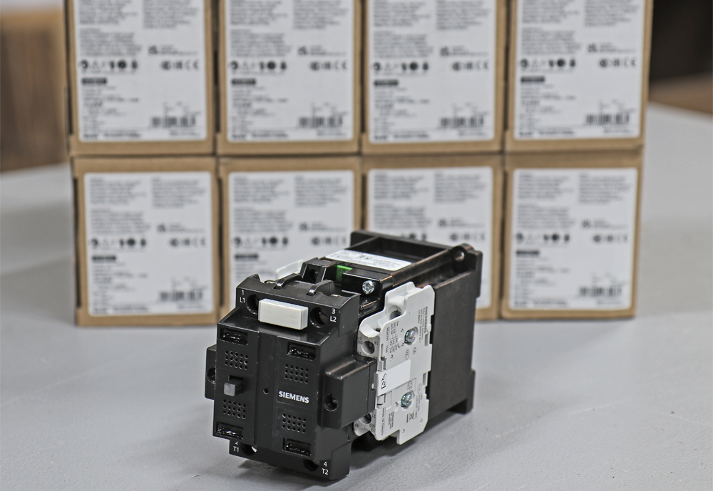siemens contactor part in front of 8 stacked boxes of the same