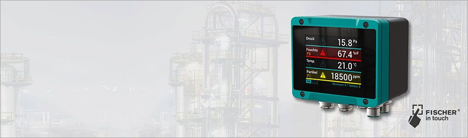 Teal Fischer in Touch industrial monitor mounted on process equipment, displaying live readings for pressure, humidity, temperature, and particle levels in a factory setting.